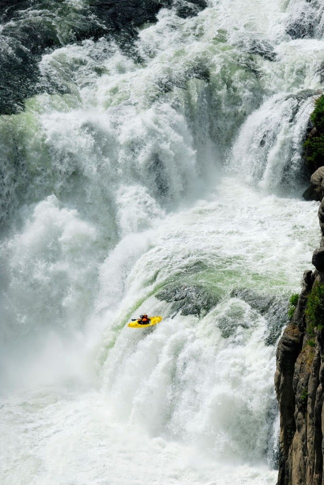 Thrill seekers and kayakers plunge over the Lower Mesa Falls in Idaho