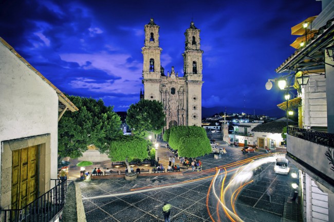 You should visit Taxco in Mexico at dusk. It looks so surreal.